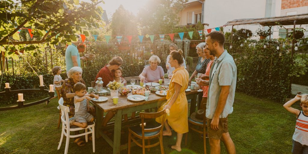 Photo of multi generation family, having party in the backyard.