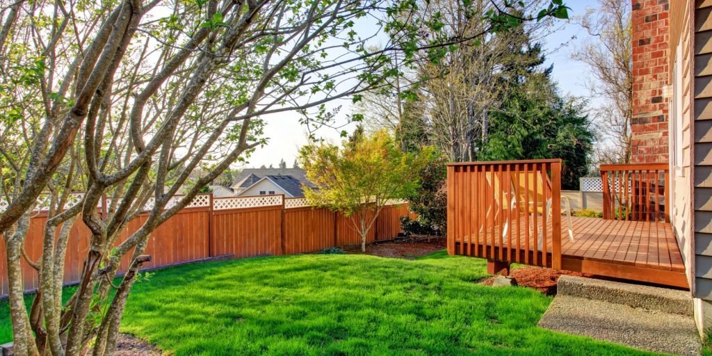 Cozy small backyard with wooden walkout deck