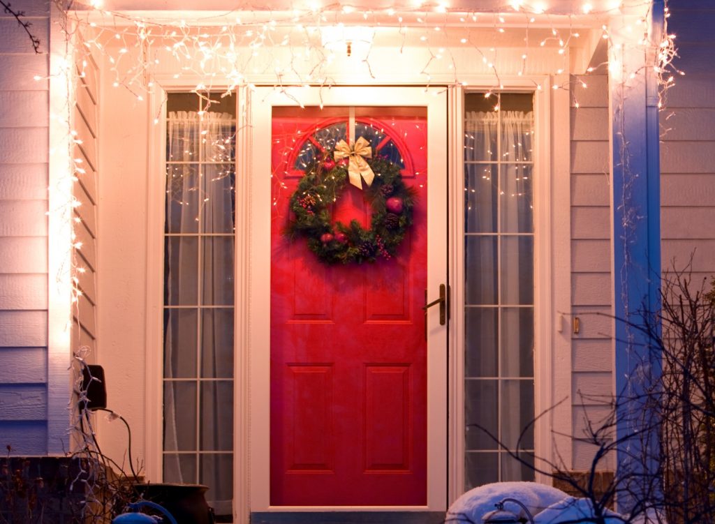 Front door with Christmas wreath and lights