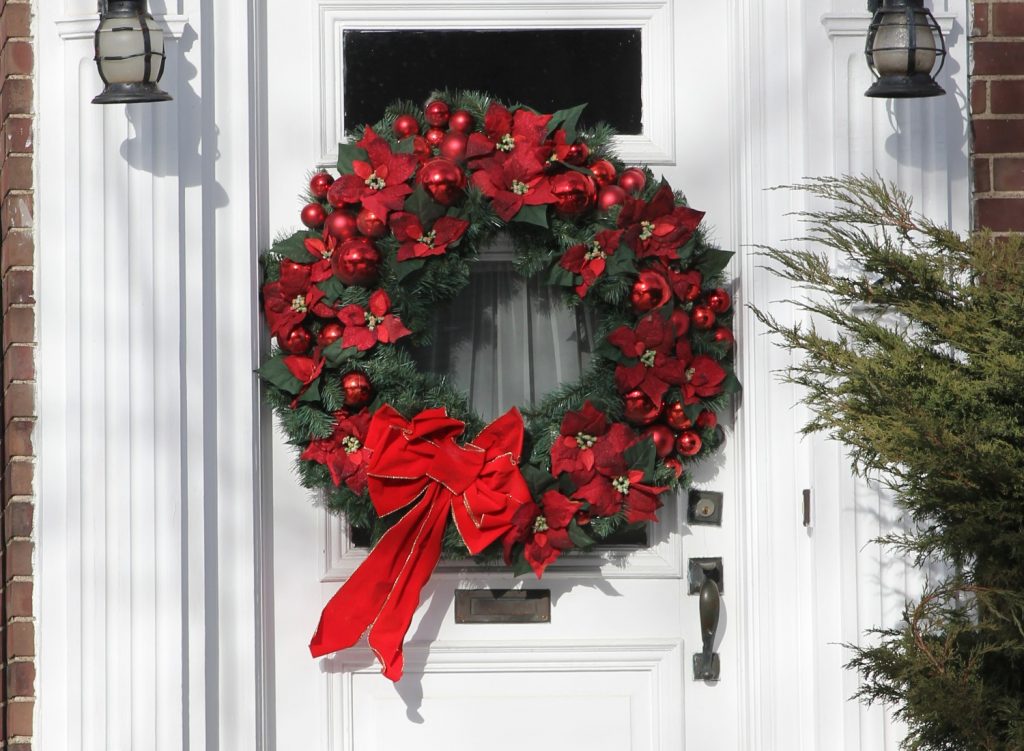 A festive wreath on a white door