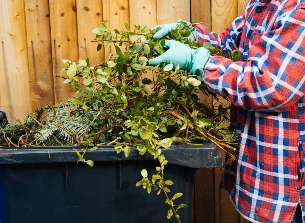 iStock-1306822710 Man disposing of yard debris